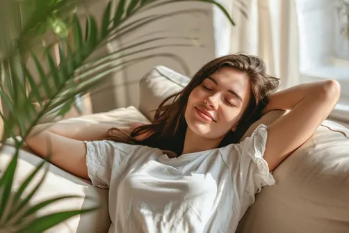 Woman lying on a couch with her eyes closed